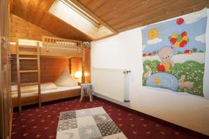a bedroom with a bunk bed and a mural on the wall at Obersteinberg-Hof in Ruhpolding