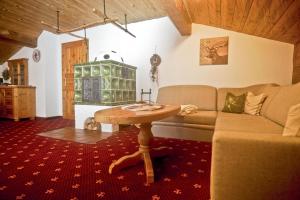 a living room with a couch and a table at Obersteinberg-Hof in Ruhpolding