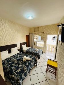 a hotel room with two beds and a balcony at Hotel Playa de Oro - Enfrente de WTC y Plazas Comerciales in Veracruz