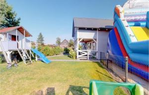 a backyard with a inflatable slide and a house at Lovely Home In Karwia With Wifi in Karwia