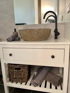 a bathroom vanity with a sink and a bowl at Stylish Guest Suite in Everton Hills in Oxford Park