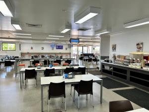 a dining room with tables and chairs and a cafeteria at Leichhardt Accommodation in Moranbah