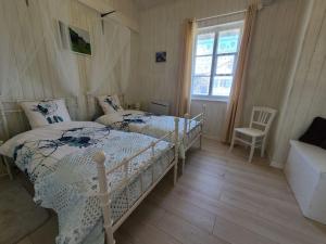 a bedroom with two beds and a window at Gîte Taintrux, 3 pièces, 4 personnes - FR-1-589-457 in Taintrux