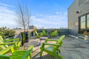 a row of green chairs and tables on a patio at Pure Relaxation-Luxury/Roof Top* in Philadelphia