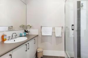 a white bathroom with a sink and a shower at Sandylands Busselton with WiFi in Vasse +21 photos