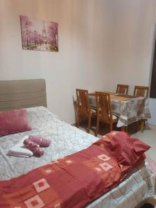 a bedroom with a bed and a table and chairs at HOME away from home_3BR at Maniatika_14min walk to the port in Piraeus