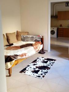 a bedroom with a bed and a rug on the floor at HOME away from home_3BR at Maniatika_14min walk to the port in Piraeus