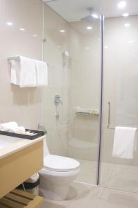 a bathroom with a shower and a toilet and a sink at Ocean Apartment in Da Nang