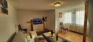 a living room with a couch and a tv at Apartament przy Rynku in Białystok