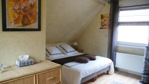 Tempat tidur dalam kamar di Chambre d'Hotes Le Vogelgarten