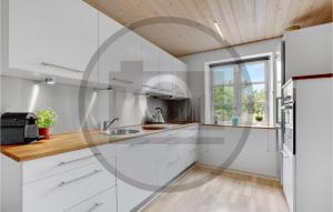 a kitchen with white cabinets and a window at Cozy Home In Nrre Nebel With Wifi in Nørre Nebel