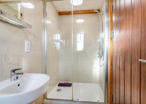 a bathroom with a shower and a sink and a toilet at Hornsea Lakeside Lodges in Hornsea