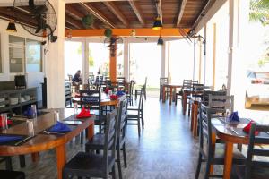 a dining room with wooden tables and chairs at The Blue Lagoon Resort Kalpitiya in Kalpitiya