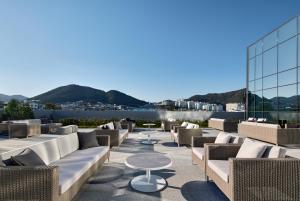 a patio with couches and tables on top of a building at Shilla Stay Yeosu in Yeosu