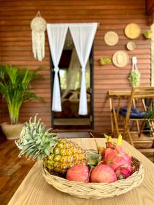 a basket of fruit sitting on a table at BEACH BUNGALOW - OUTDOOR net on the beach - Working Desk in Lipa Noi