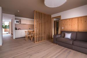 a living room with a couch and a table at Mölgg Dolomites Residence in San Vigilio Di Marebbe