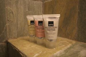 a group of three bottles of moisturizers on a counter at de King Boutique Hotel KLCC in Kuala Lumpur