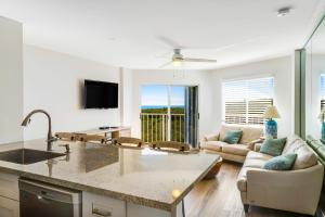 a kitchen and living room with a couch and a table at Nauti Hideaway, Unit #2314 in Tavernier