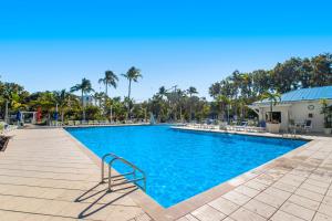 a swimming pool with blue water in a resort at Nauti Hideaway, Unit #2314 in Tavernier