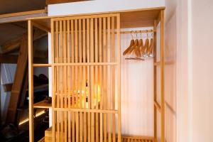 a wooden book shelf with utensils in it at Sumiya Rakusuitei - Vacation STAY 16647v in Takayama