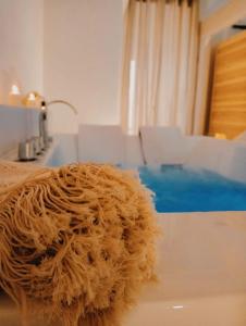 a brown teddy bear sitting on a bathroom sink at Antica Dimora in Lizzano +64 photos
