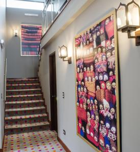 a painting on the wall of a hallway with stairs at Atiq Boutique Hotel in Cusco