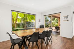 a dining room with a wooden table and chairs at Shallow Water Retreat in Cowes