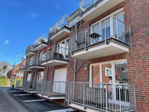 a row of balconies on a brick building at Mühlenstraße 19 Ferienwohnung 50227 in Carolinensiel