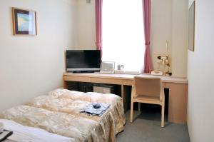富良野的住宿－申富來登酒店，客房设有一张桌子、一台电脑和一把椅子