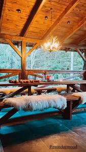 a room with a wooden table with a furry couch at Domicil Donky in Donovaly