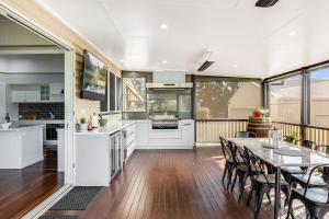 a kitchen and dining room with a table and chairs at Elegant, Stunning & Central! East Side Gem! in Toowoomba