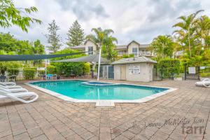 a swimming pool in front of a house at Bayview Bay Apartment and Marina in Gold Coast