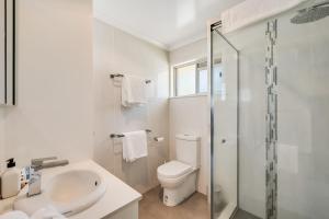 a bathroom with a toilet and a sink and a shower at Perfect CDB & Parkland Fringe! in Toowoomba