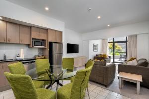 a kitchen and living room with a glass table and chairs at Lantern 17 Deluxe - Parking in Thredbo