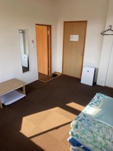Postel nebo postele na pokoji v ubytování Guest House Iwato