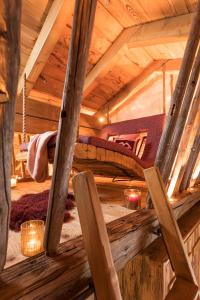 a room with a bed in a wooden cabin at LaPosch - Dein Bergaway in Biberwier