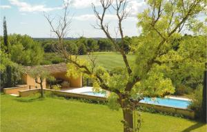 an external view of a villa with a swimming pool and a tree at Gorgeous Home In Bziers With Swimming Pool in Montblanc