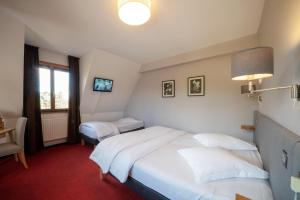 Postel nebo postele na pokoji v ubytování Hôtel Le Verger De Bischwiller