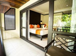 1 dormitorio con 1 cama y balcón en Am Samui Palace, en Lamai