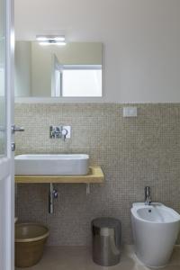 a bathroom with a sink and a toilet at Trapetum-Salento domus in Cursi