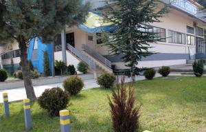 a building with a tree in front of it at Hotel Centar in Skopje