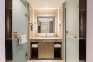 a bathroom with a sink and a mirror at Chengdu Prolit Hotel in Chengdu