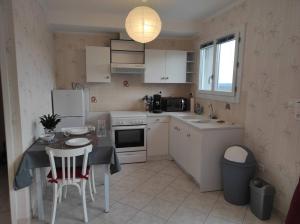 a kitchen with a table and a table and chairs at Trespouz'en in Trespoux-Rassiels