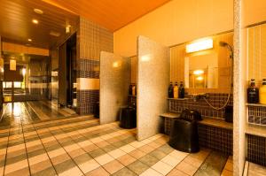 a bathroom with a sink and a mirror at Dormy Inn Premium Kyoto Ekimae Natural Hot Spring in Kyoto
