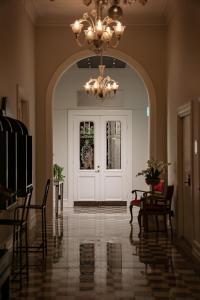 a hallway with a white door and a chandelier at Continental du Sud in Ystad