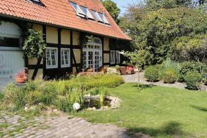 een zwart-wit huis met een tuin ervoor bij Xanadi Heilehaus kleine Auszeit Kururlaub in Bruchhausen-Vilsen