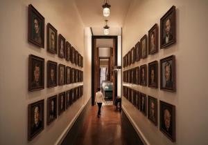 a woman walking down a hallway with pictures on the walls at Andaz Shenzhen Bay in Shenzhen