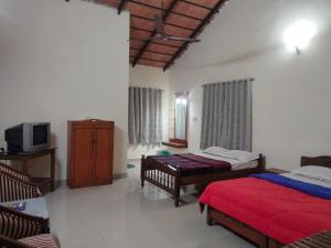 Säng eller sängar i ett rum på Prashanth Homestay