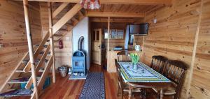a dining room with a table and a wood stove at Domki Drewniane Królewska Góra in Czarnorzeki +151 photos