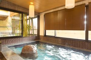 a swimming pool with a turtle in a room with windows at Dormy Inn Premium Kyoto Ekimae Natural Hot Spring in Kyoto